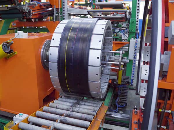 A tire tread machine part of a tire manufacturing plant